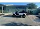 Charming golf cart in front of a light blue house, perfect for enjoying the community and local amenities at 324 Plaza Blvd, Daytona Beach, FL 32118