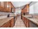 Modern kitchen with wood cabinets, tiled countertops, and modern appliances, providing a stylish and functional cooking space at 324 Plaza Blvd, Daytona Beach, FL 32118