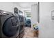Well-equipped laundry room with a large washer and dryer, complemented by storage solutions at 324 Plaza Blvd, Daytona Beach, FL 32118