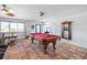 Open concept living area featuring a pool table, tile floors, modern lighting, and a cozy seating area at 324 Plaza Blvd, Daytona Beach, FL 32118
