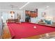 Open-concept living space with a pool table, dining area, and seating area, providing ample room for relaxation at 324 Plaza Blvd, Daytona Beach, FL 32118