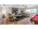 Stylish living room with comfortable seating, a modern fireplace, and a view of the surrounding greenery at 324 Plaza Blvd, Daytona Beach, FL 32118