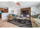 Open living room with a modern entertainment center, comfortable seating, and a clear view of the adjacent kitchen area at 324 Plaza Blvd, Daytona Beach, FL 32118