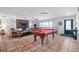 Spacious living room with pool table, designer walls, stylish tile flooring, and lots of natural light at 324 Plaza Blvd, Daytona Beach, FL 32118