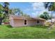 Expansive backyard with lush lawn and minimal landscaping, showcasing the property's spaciousness at 330 Ponce Deleon Blvd, De Leon Springs, FL 32130