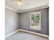 Neutral bedroom featuring a window, wall-to-wall carpet, light ceiling fan and simple decor at 330 Ponce Deleon Blvd, De Leon Springs, FL 32130