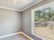 Carpeted bedroom featuring neutral paint, white trim, and a window with natural light at 330 Ponce Deleon Blvd, De Leon Springs, FL 32130