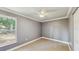 Cozy bedroom with plush carpet, a bright window, and neutral color scheme at 330 Ponce Deleon Blvd, De Leon Springs, FL 32130