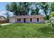 Attractive single-Gathering home with green lawn, features a garage, and neutral exterior at 330 Ponce Deleon Blvd, De Leon Springs, FL 32130