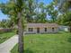 Charming home featuring a well-maintained front yard with mature trees and a driveway at 330 Ponce Deleon Blvd, De Leon Springs, FL 32130