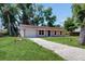 Charming single-story home with a well-maintained lawn and attached garage at 330 Ponce Deleon Blvd, De Leon Springs, FL 32130