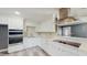 Bright kitchen with stainless steel appliances, white cabinetry and decorative tile backsplash at 330 Ponce Deleon Blvd, De Leon Springs, FL 32130