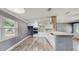 Modern white kitchen with stainless steel appliances, mosaic backsplash, and a breakfast bar at 330 Ponce Deleon Blvd, De Leon Springs, FL 32130