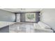 Bright living room featuring durable, marble-look flooring, a ceiling fan, and natural light at 330 Ponce Deleon Blvd, De Leon Springs, FL 32130
