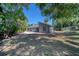 Spacious backyard with mature trees, lush greenery and unique architectural home at 330 Wall Ave, Ormond Beach, FL 32174