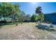 Expansive backyard featuring large trees, a lush green lawn, and natural landscaping at 330 Wall Ave, Ormond Beach, FL 32174