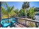 Exterior view of balcony with two blue chairs and view of palm trees at 330 Wall Ave, Ormond Beach, FL 32174