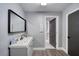 Contemporary bathroom featuring gray walls, black mirror, and an open doorway at 330 Wall Ave, Ormond Beach, FL 32174