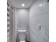 Modern bathroom features white marble-look tiles and recessed lighting at 330 Wall Ave, Ormond Beach, FL 32174