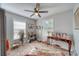 Cozy bedroom with lots of natural light from two windows and a ceiling fan at 330 Wall Ave, Ormond Beach, FL 32174