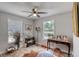 Bright bedroom with ceiling fan, two windows, and vintage decorations at 330 Wall Ave, Ormond Beach, FL 32174