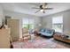 Light-filled bedroom features a ceiling fan, two windows, and a spacious layout at 330 Wall Ave, Ormond Beach, FL 32174