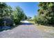 Long driveway leading to a home surrounded by mature trees and lush landscaping at 330 Wall Ave, Ormond Beach, FL 32174