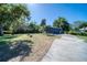 A detached garage with a lush lawn and mature trees at 330 Wall Ave, Ormond Beach, FL 32174