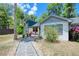 Charming single-story home with a stone walkway, inviting front porch, and colorful landscaping at 330 Wall Ave, Ormond Beach, FL 32174
