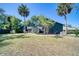 Charming two-story home featuring lush lawn, mature trees, and blue siding in a picturesque neighborhood at 330 Wall Ave, Ormond Beach, FL 32174
