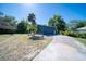 Detached garage with blue siding and mature trees at 330 Wall Ave, Ormond Beach, FL 32174