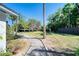A stone path surrounded by green grass and mature trees at 330 Wall Ave, Ormond Beach, FL 32174