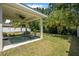 Backyard with lush green lawn and covered patio is ideal for outdoor living at 43 Pergola Pl, Ormond Beach, FL 32174