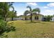 Large backyard with lush lawn and covered patio provides a private outdoor space at 43 Pergola Pl, Ormond Beach, FL 32174