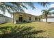 Spacious backyard features a well-maintained lawn and covered patio area at 43 Pergola Pl, Ormond Beach, FL 32174