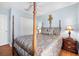 Tastefully decorated bedroom featuring a four-poster bed with stylish bedding, side tables and a double door closet at 43 Pergola Pl, Ormond Beach, FL 32174