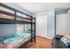 Bedroom featuring black bunk beds, a leather couch, and white double door closet providing ample storage space at 43 Pergola Pl, Ormond Beach, FL 32174
