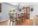 Elegant dining room with a large wooden table, chandelier, and sliding glass doors at 43 Pergola Pl, Ormond Beach, FL 32174