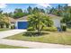 Beautifully landscaped front yard with healthy green lawn and vibrant landscaping surrounding a well-maintained one-story home at 43 Pergola Pl, Ormond Beach, FL 32174