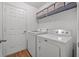 Bright laundry room featuring a washer, dryer, and storage shelving at 43 Pergola Pl, Ormond Beach, FL 32174