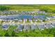 Aerial view of a lakeside residential community with single-Gathering homes and lush landscaping at 5635 Estero Loop, Port Orange, FL 32128