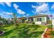 Large backyard with a manicured lawn, brick edging, and privacy fencing, perfect for outdoor activities at 5635 Estero Loop, Port Orange, FL 32128