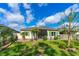 Expansive backyard with brick-paved patio, lush green lawn, and mature trees creating a private oasis at 5635 Estero Loop, Port Orange, FL 32128