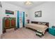 Bright bedroom with a patterned bed, turquoise accents, a plush carpet, and a window with sheer curtains at 5635 Estero Loop, Port Orange, FL 32128