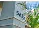 Close-up of the house number, highlighted by modern design and lush tropical foliage at 5635 Estero Loop, Port Orange, FL 32128