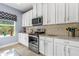 Well-lit kitchen featuring white cabinets, stainless steel appliances, and granite countertops at 5635 Estero Loop, Port Orange, FL 32128