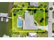 Aerial view of a home with a pool, manicured lawn, and a private boat lift on the water at 5809 Riverside Dr, Port Orange, FL 32127