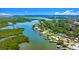 Scenic aerial view of waterfront homes along a lush green coastline with boats docked in the bay at 5809 Riverside Dr, Port Orange, FL 32127