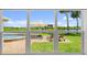 A beautiful backyard view with a pool and lounge chairs is visible from the large window at 5809 Riverside Dr, Port Orange, FL 32127