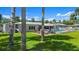 Backyard with an outdoor pool and tropical palm trees at 5809 Riverside Dr, Port Orange, FL 32127